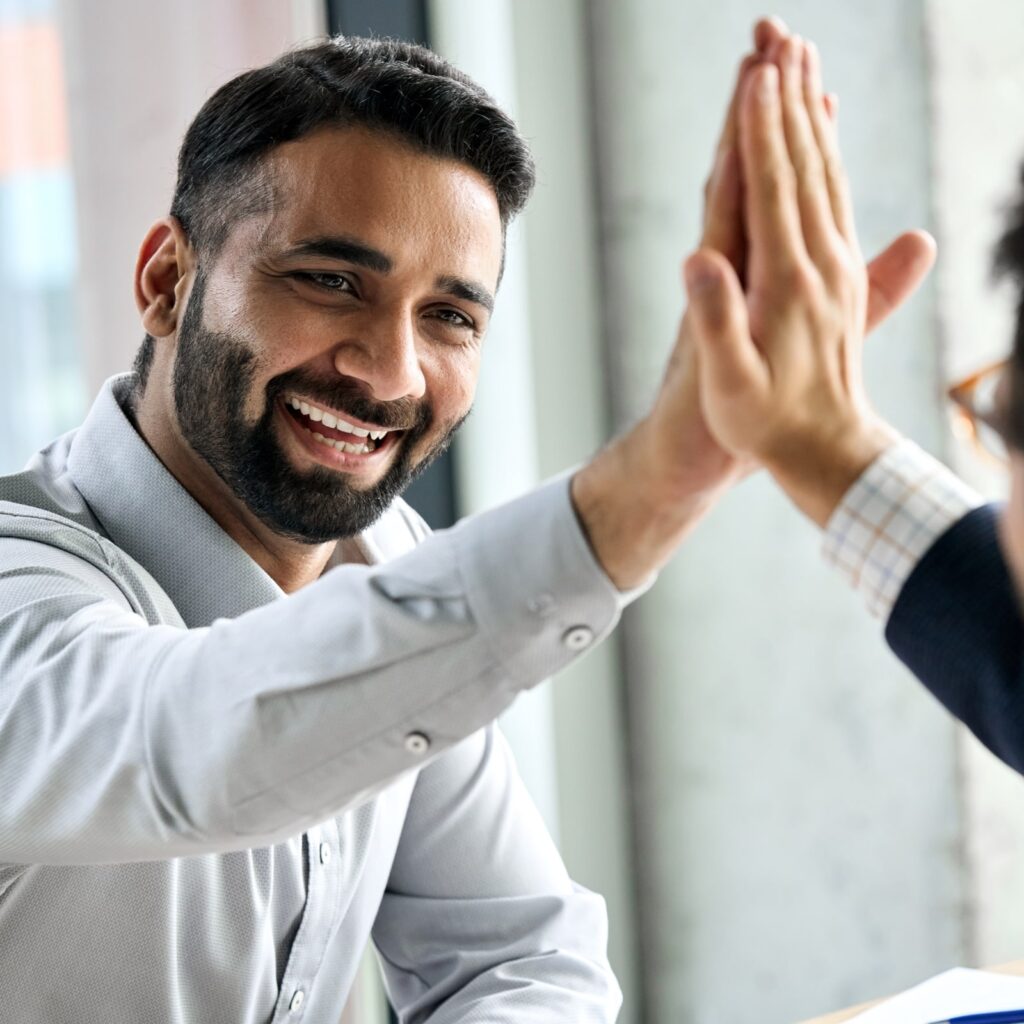 happy smiling man giving high five to partner